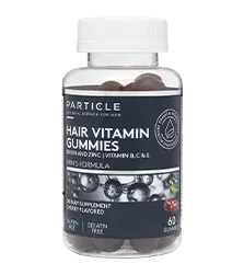 Plastic transparent bottle labeled Particle Hair Vitamin Gummies with dark-colored gummies inside.
